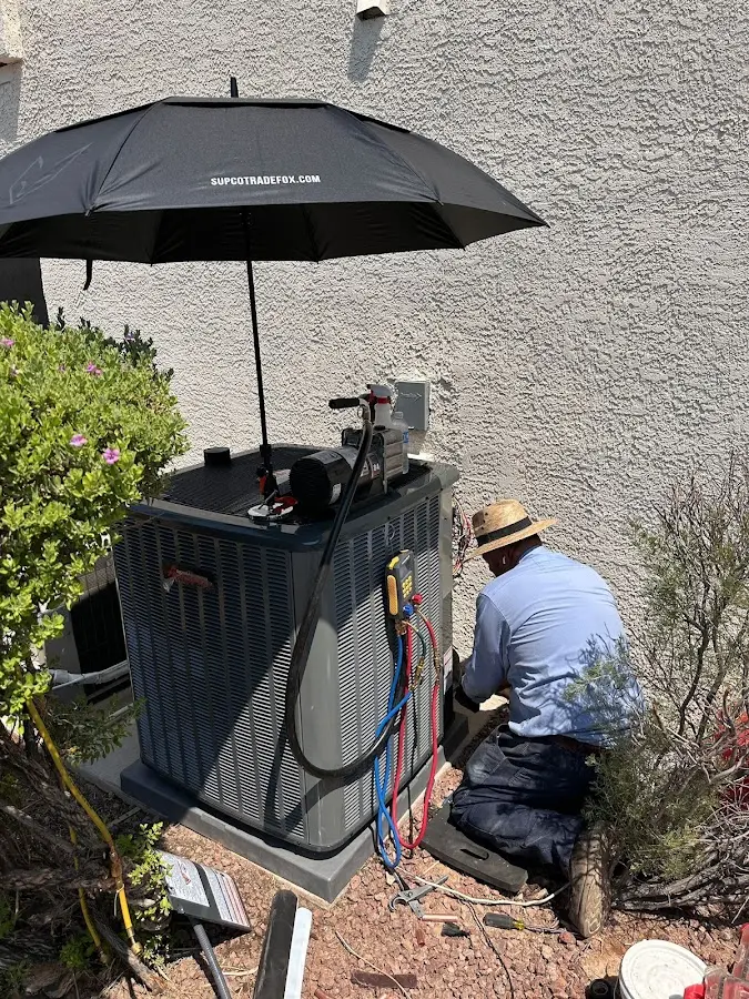 HVAC technician performing outdoor AC maintenance in Mansfield